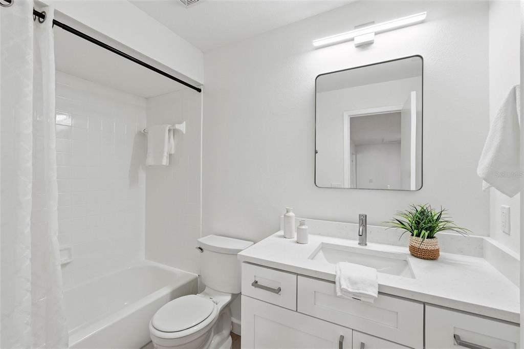 404 Bryan Oak Avenue Brandon, FL 33511 - Photo 25 of 43 a bathroom with a sink toilet a mirror and shower