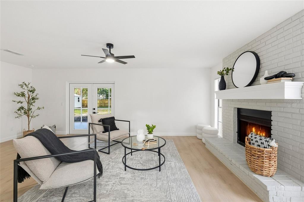 404 Bryan Oak Avenue Brandon, FL 33511 - Photo 4 of 43 a living room with fireplace furniture and a potted plant
