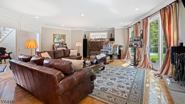 a living room with furniture a rug and a large window