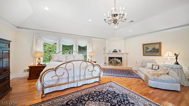 a spacious bedroom with a bed a dresser and dresser next to a window