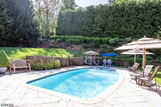 a view of a chair and table in backyard of the house
