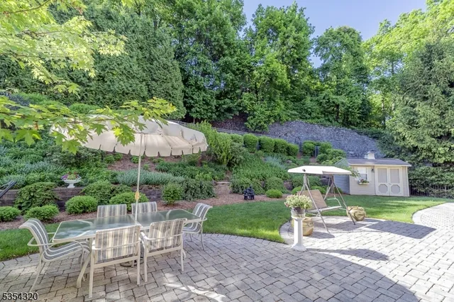 an aerial view of a house with yard swimming pool and outdoor seating