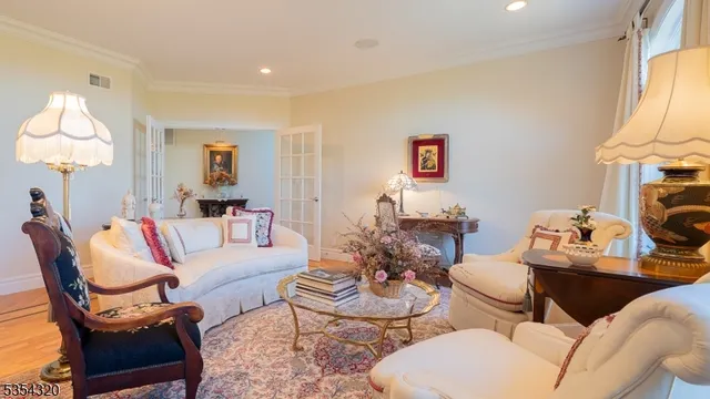 a view of a dining room with furniture a chandelier and wooden floor
