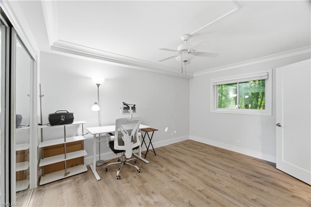 975 9th Avenue South, Unit 11 Naples, FL 34102 - Photo 11 of 19 a view of a workspace with wooden floor and a window