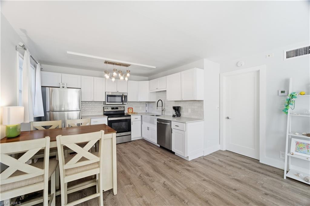 975 9th Avenue South, Unit 11 Naples, FL 34102 - Photo 4 of 19 a kitchen with a table and chairs in it