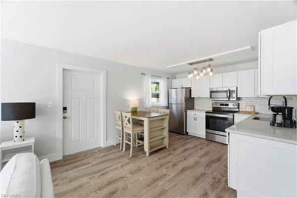 a kitchen with a sink a counter top space stainless steel appliances and a window