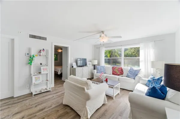 a living room with furniture and wooden floor