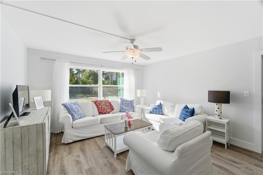 975 9th Avenue South, Unit 11 Naples, FL 34102 - Photo 9 of 19 a living room with furniture and a flat screen tv