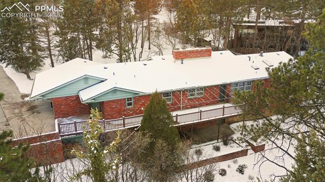 20 Thayer Road Colorado Springs, CO 80906 - Photo 2 of 9 An aerial view showing the extensive decking and treed property.