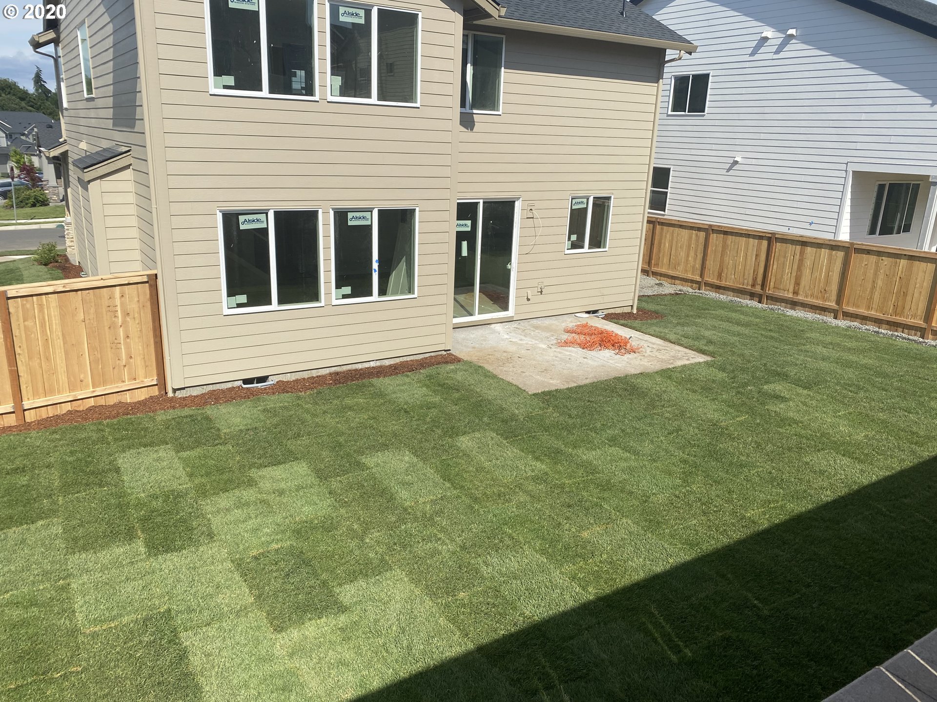 3705 South 40th Place Ridgefield, WA 98642 - Photo 18 of 18 a backyard of white house with large window and wooden fence