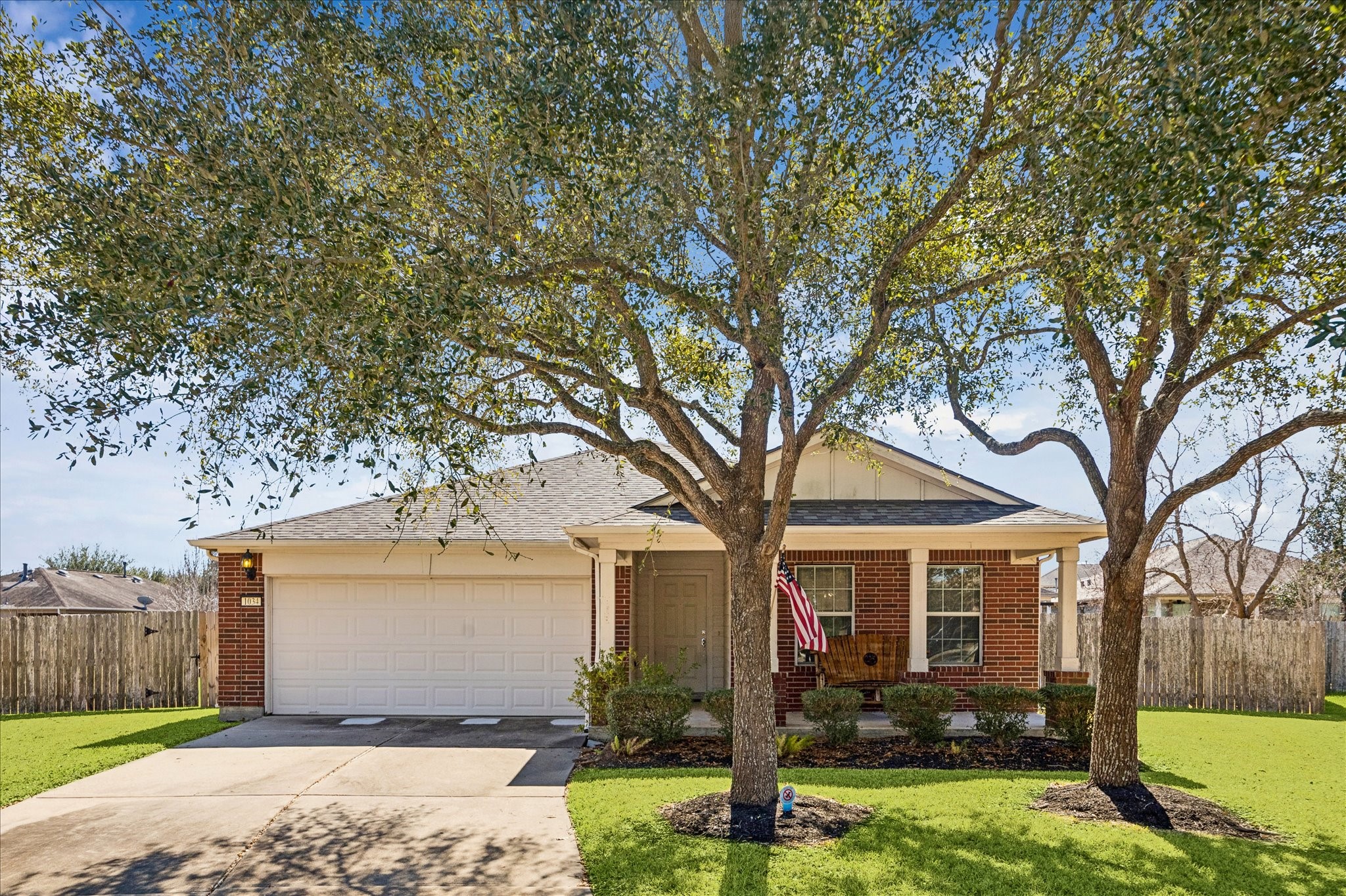 a front view of house with yard and trees around