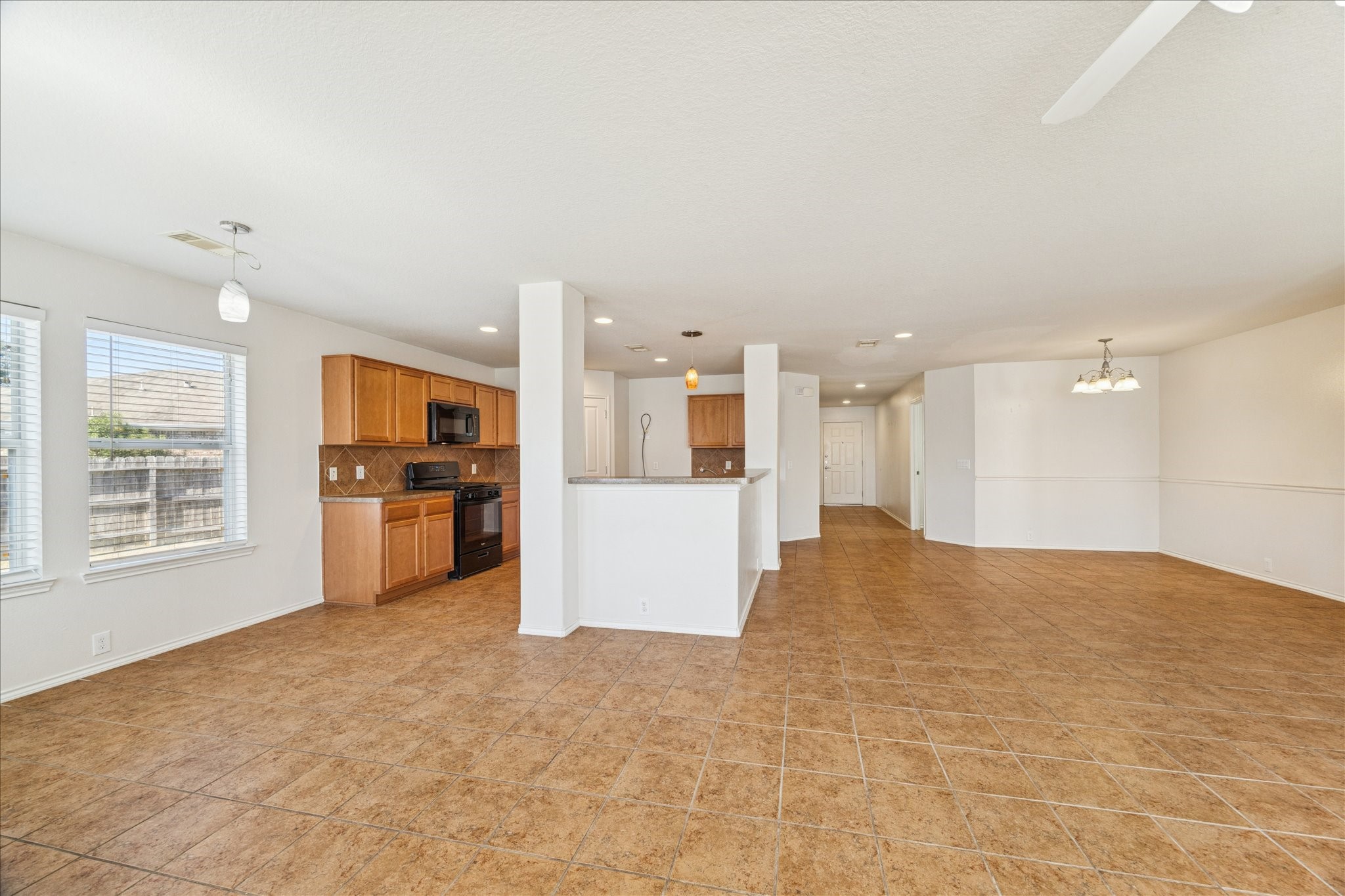 1034 Clover Leaf Court Rosenberg, TX 77469 - Photo 12 of 21 a view of an empty room with kitchen and a window