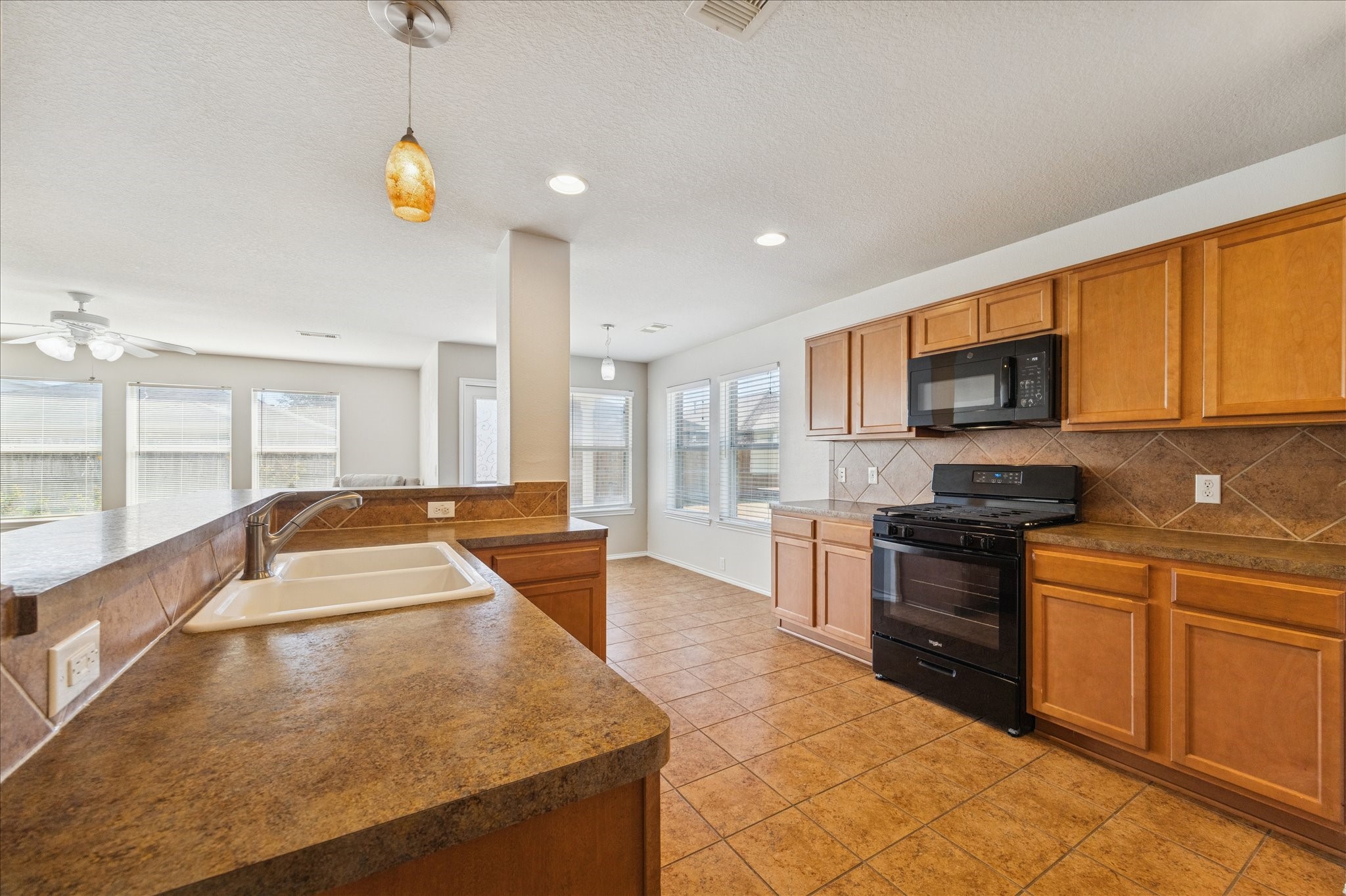 1034 Clover Leaf Court Rosenberg, TX 77469 - Photo 13 of 21 a large kitchen with stainless steel appliances granite countertop a sink and cabinets