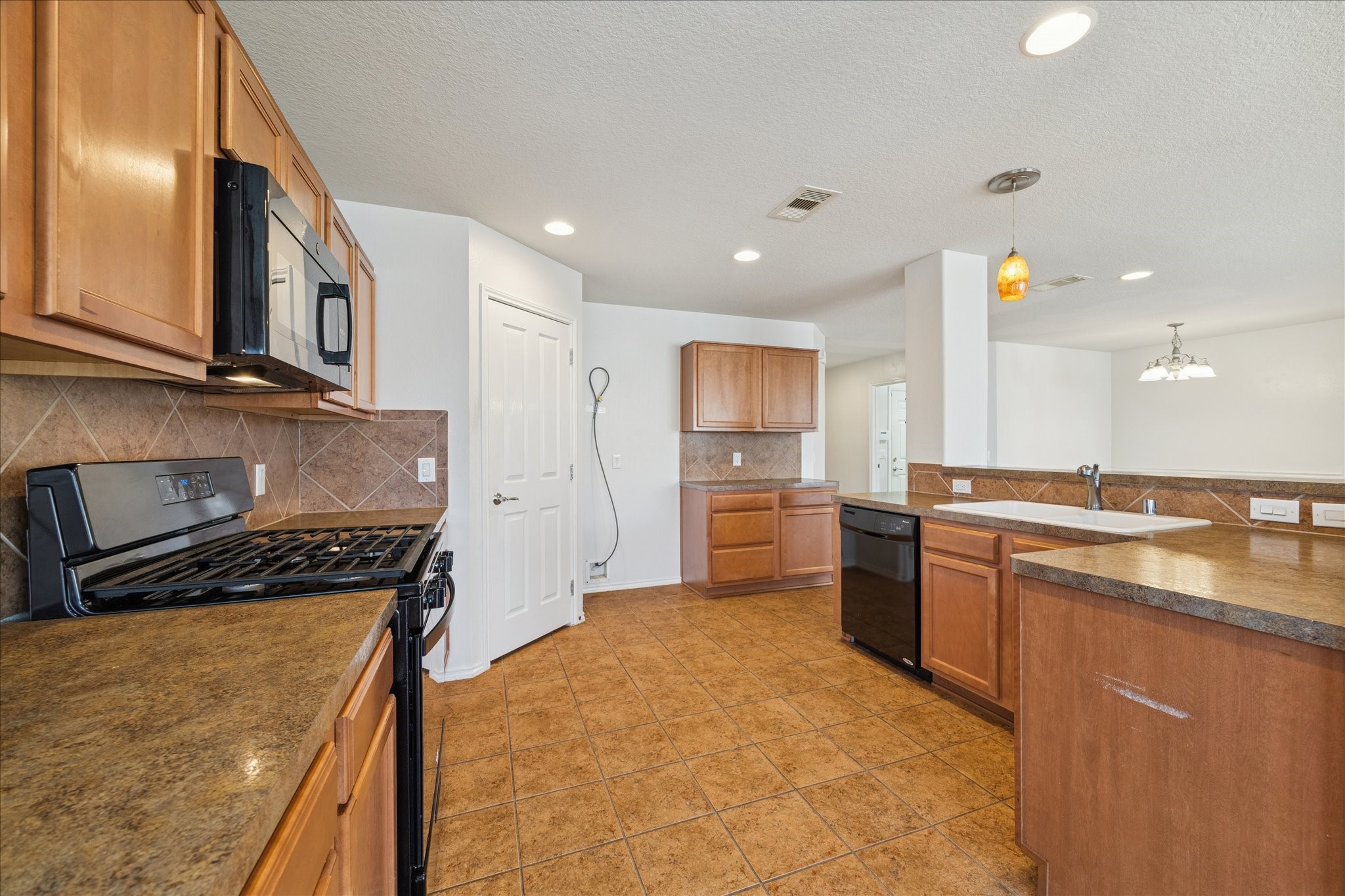 1034 Clover Leaf Court Rosenberg, TX 77469 - Photo 3 of 21 a kitchen with a sink stove and refrigerator