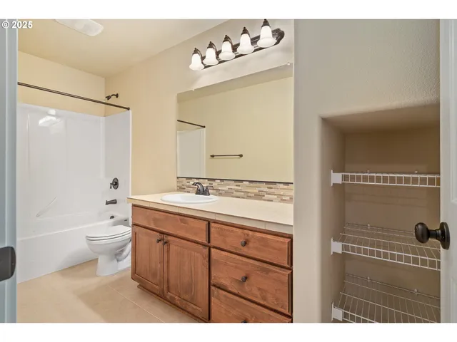 a bathroom with a double vanity sink mirror double toilet and shower