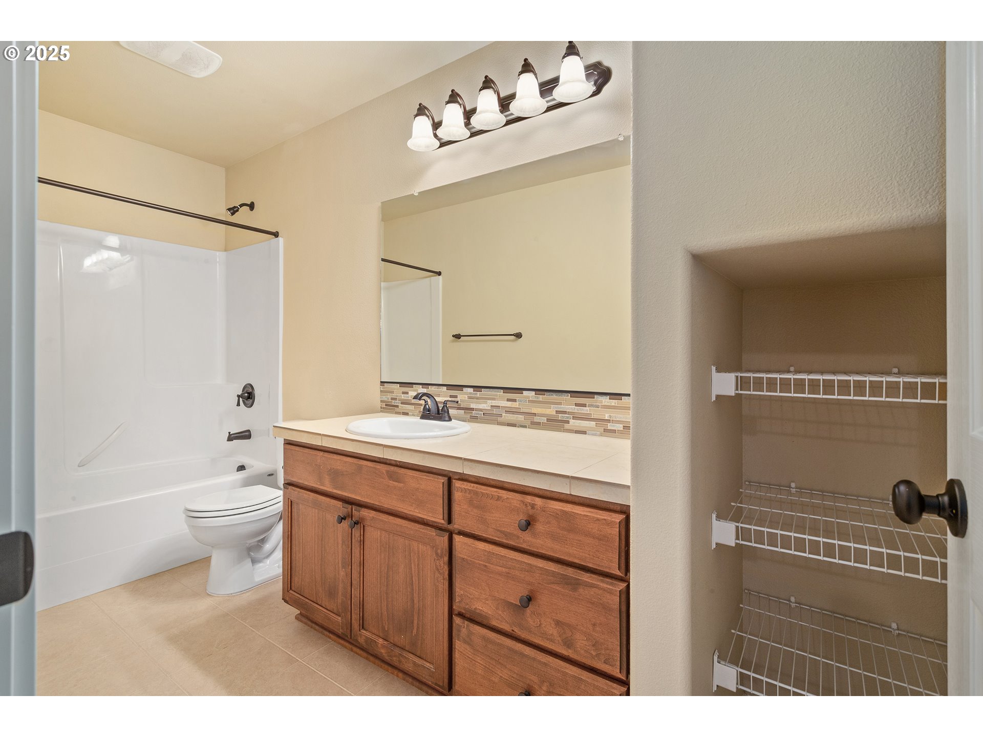 17515 Southwest Vanguard Lane Beaverton, OR 97007 - Photo 25 of 34 a bathroom with a double vanity sink mirror double toilet and shower