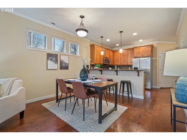 a view of a dining room with furniture and wooden floor