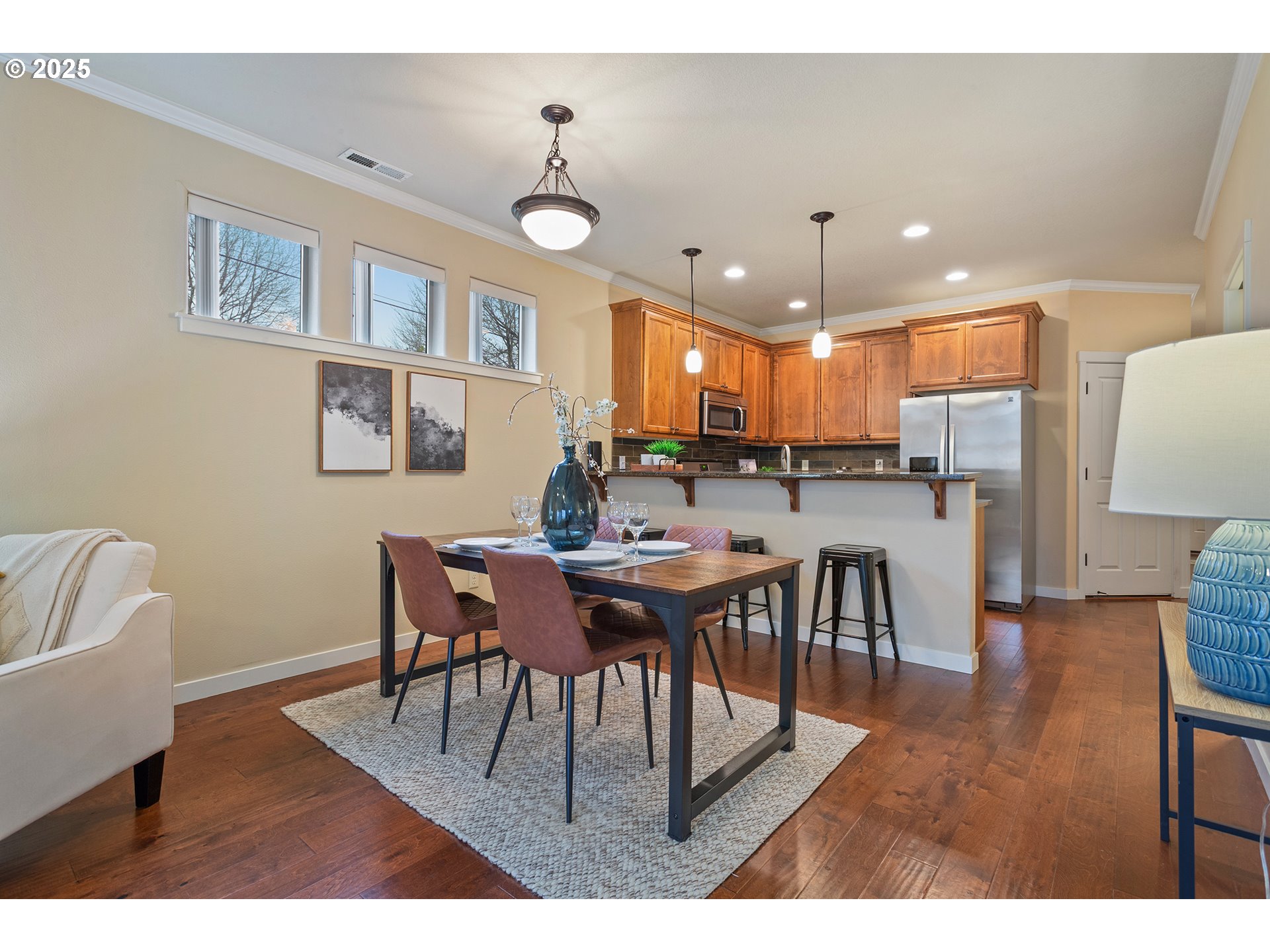 17515 Southwest Vanguard Lane Beaverton, OR 97007 - Photo 7 of 34 a view of a dining room with furniture and wooden floor