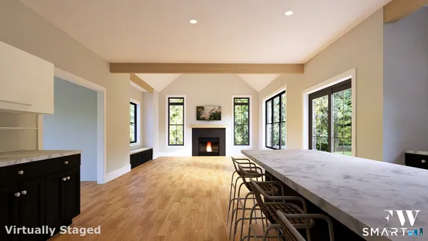 a view of a livingroom with a fireplace window and wooden floor