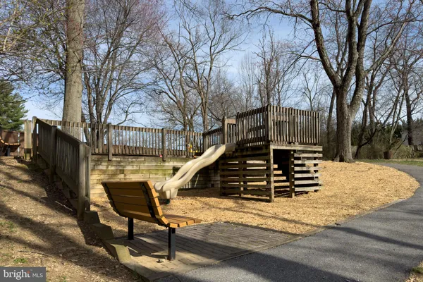 a view of a bench on the side of road