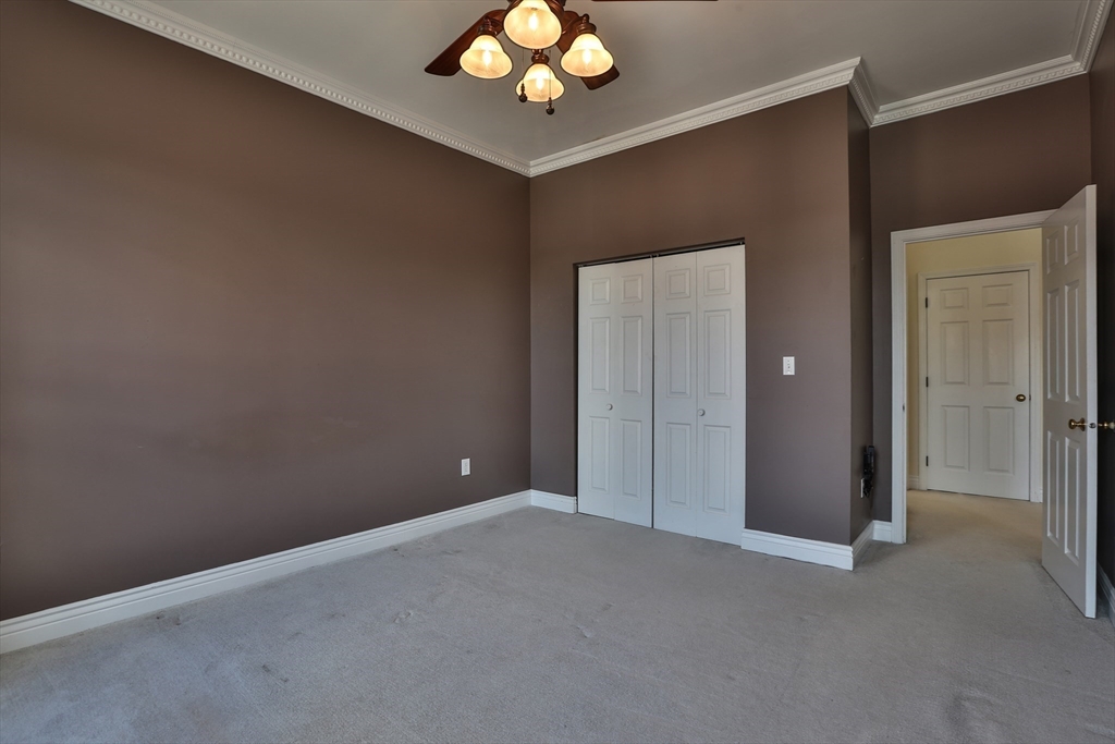 21 South Street, Unit 31 Westborough, MA 01581 - Photo 13 of 19 a view of an empty room with a chandelier fan