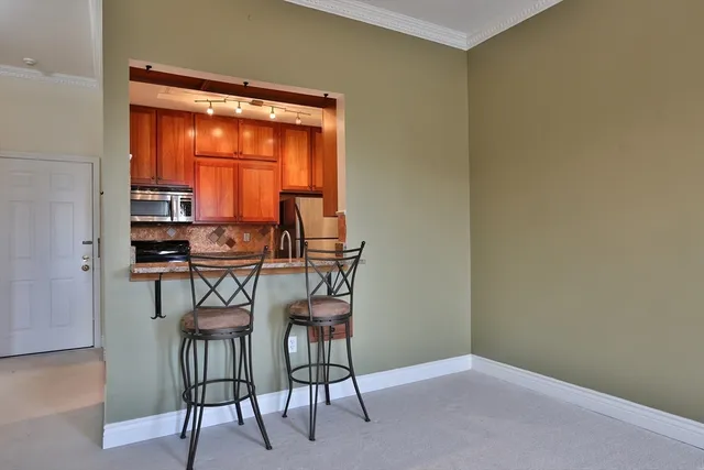 a dining room with furniture and a window