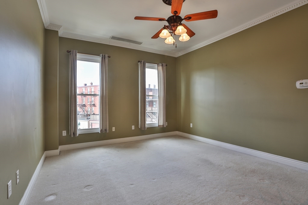 21 South Street, Unit 31 Westborough, MA 01581 - Photo 7 of 19 an empty room with windows and chandelier fan