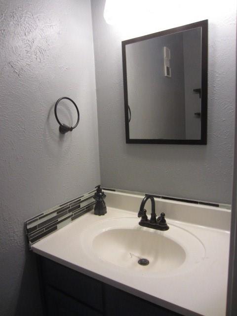 4262 Madera Road Irving, TX 75038 - Photo 8 of 15 a bathroom with a sink and a mirror