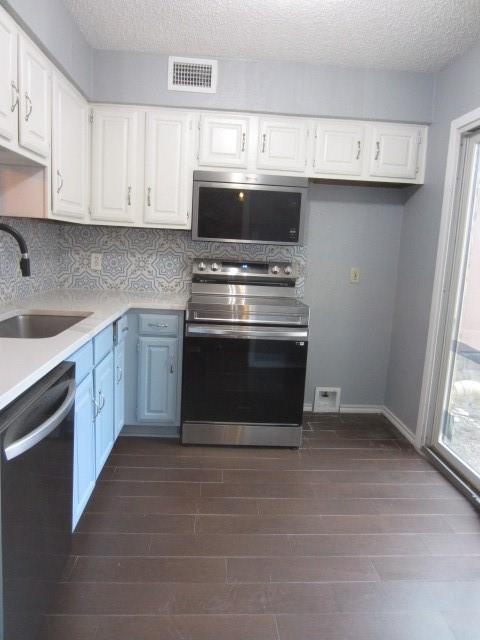 4262 Madera Road Irving, TX 75038 - Photo 10 of 15 a kitchen with stainless steel appliances a stove a sink and a microwave