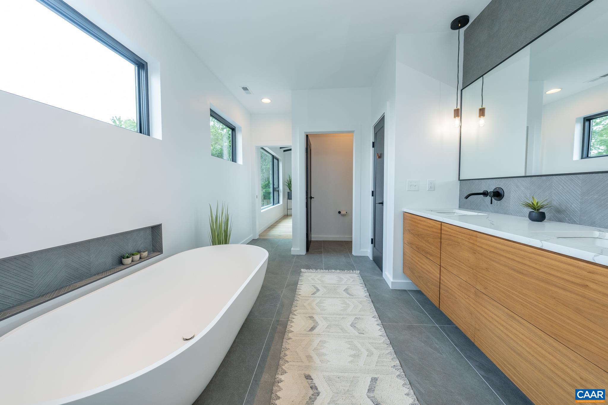 809 Gilliams Mountain Road Charlottesville, VA 22903 - Photo 36 of 68 a spacious bathroom with a tub sink and mirror