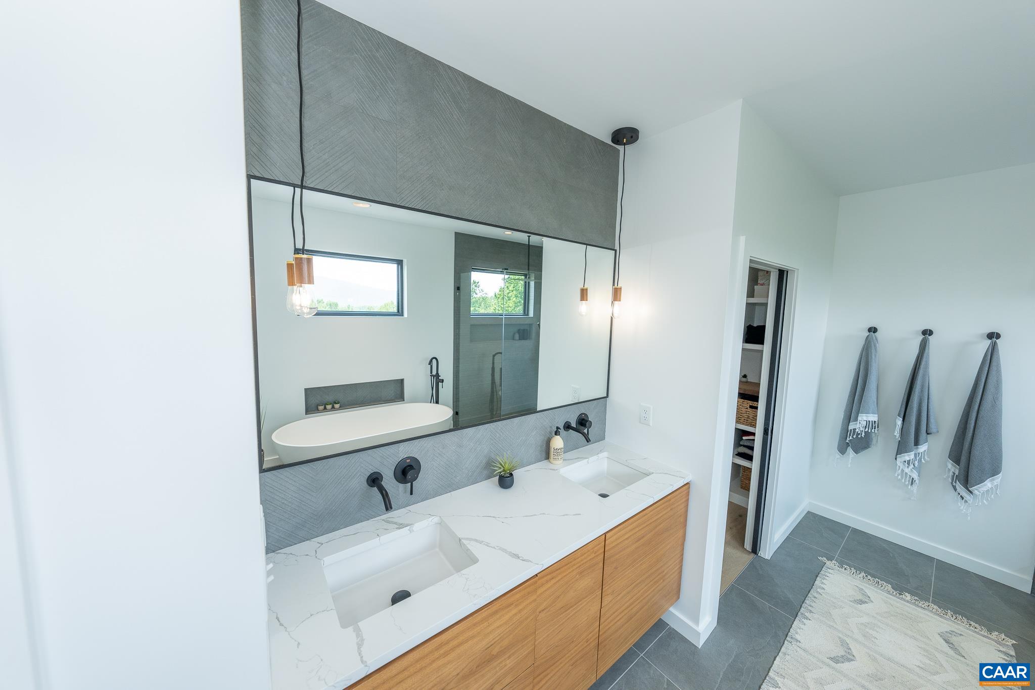 809 Gilliams Mountain Road Charlottesville, VA 22903 - Photo 39 of 68 a bathroom with a tub sink and mirror