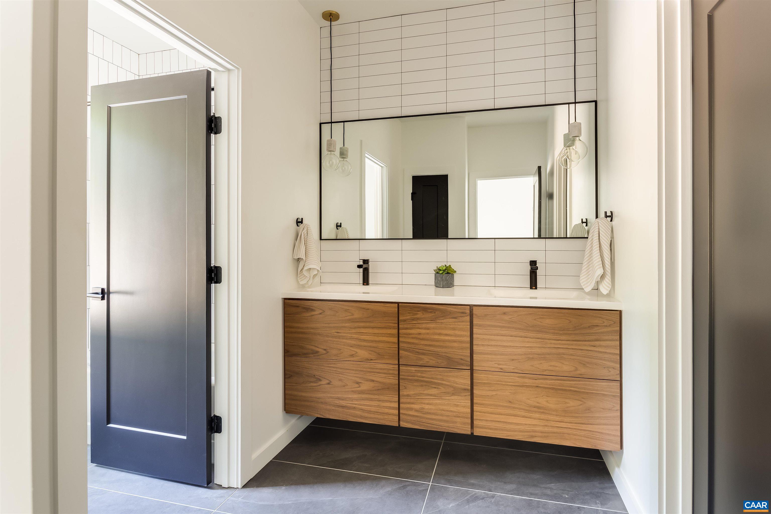 809 Gilliams Mountain Road Charlottesville, VA 22903 - Photo 47 of 68 a bathroom with a sink and a mirror
