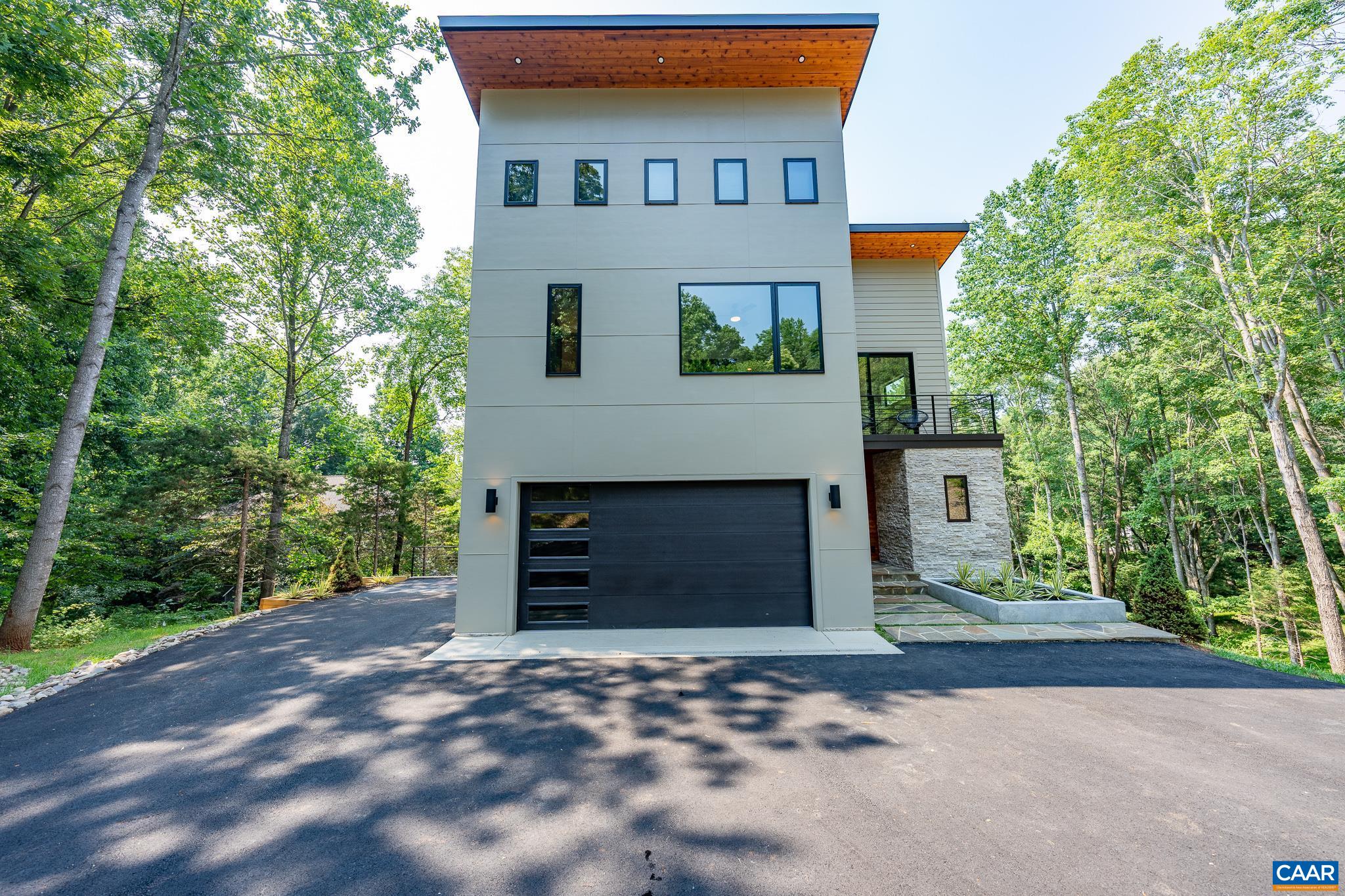 809 Gilliams Mountain Road Charlottesville, VA 22903 - Photo 51 of 68 a front view of a house with a yard and garage