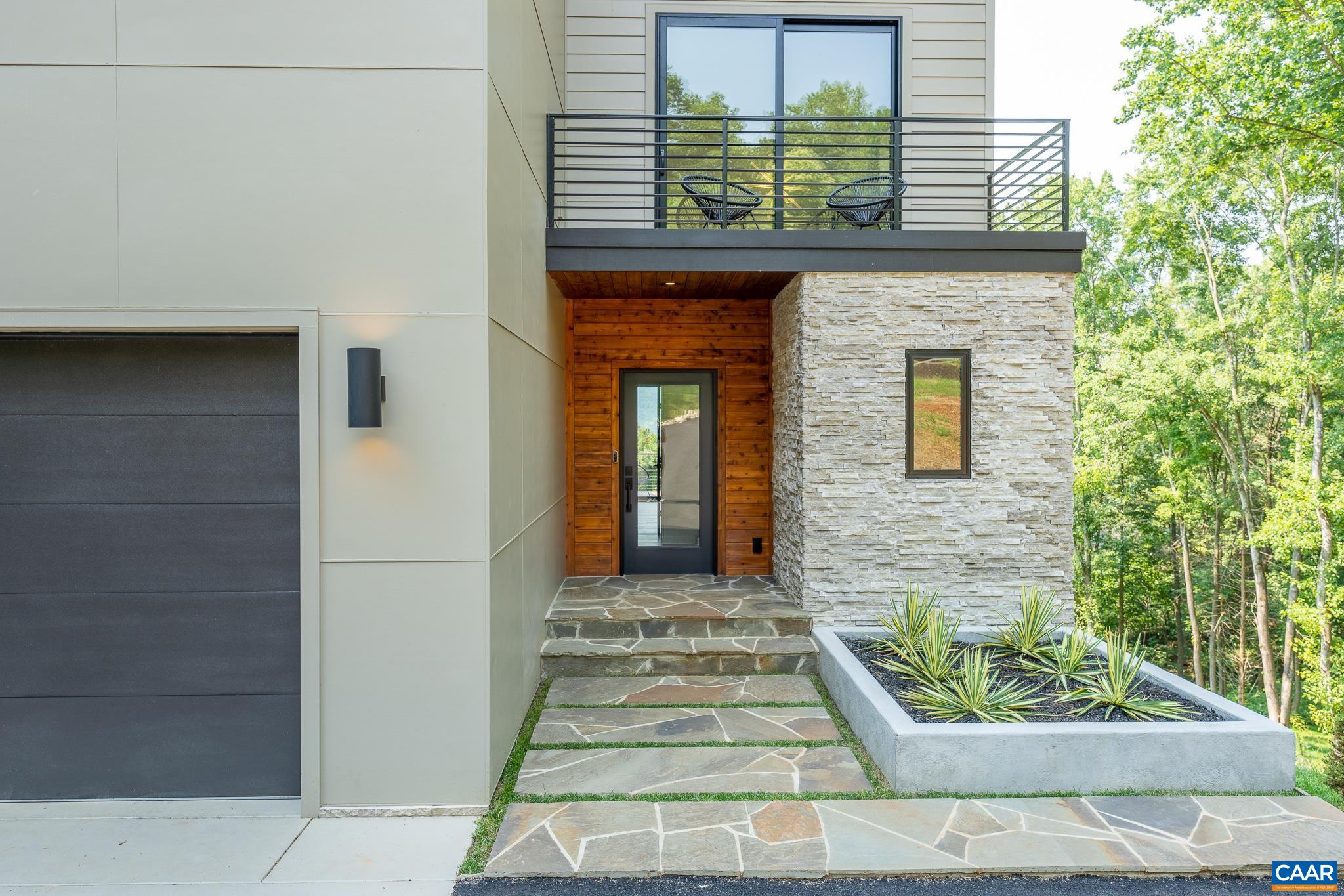 809 Gilliams Mountain Road Charlottesville, VA 22903 - Photo 53 of 68 a front view of a house with a garden