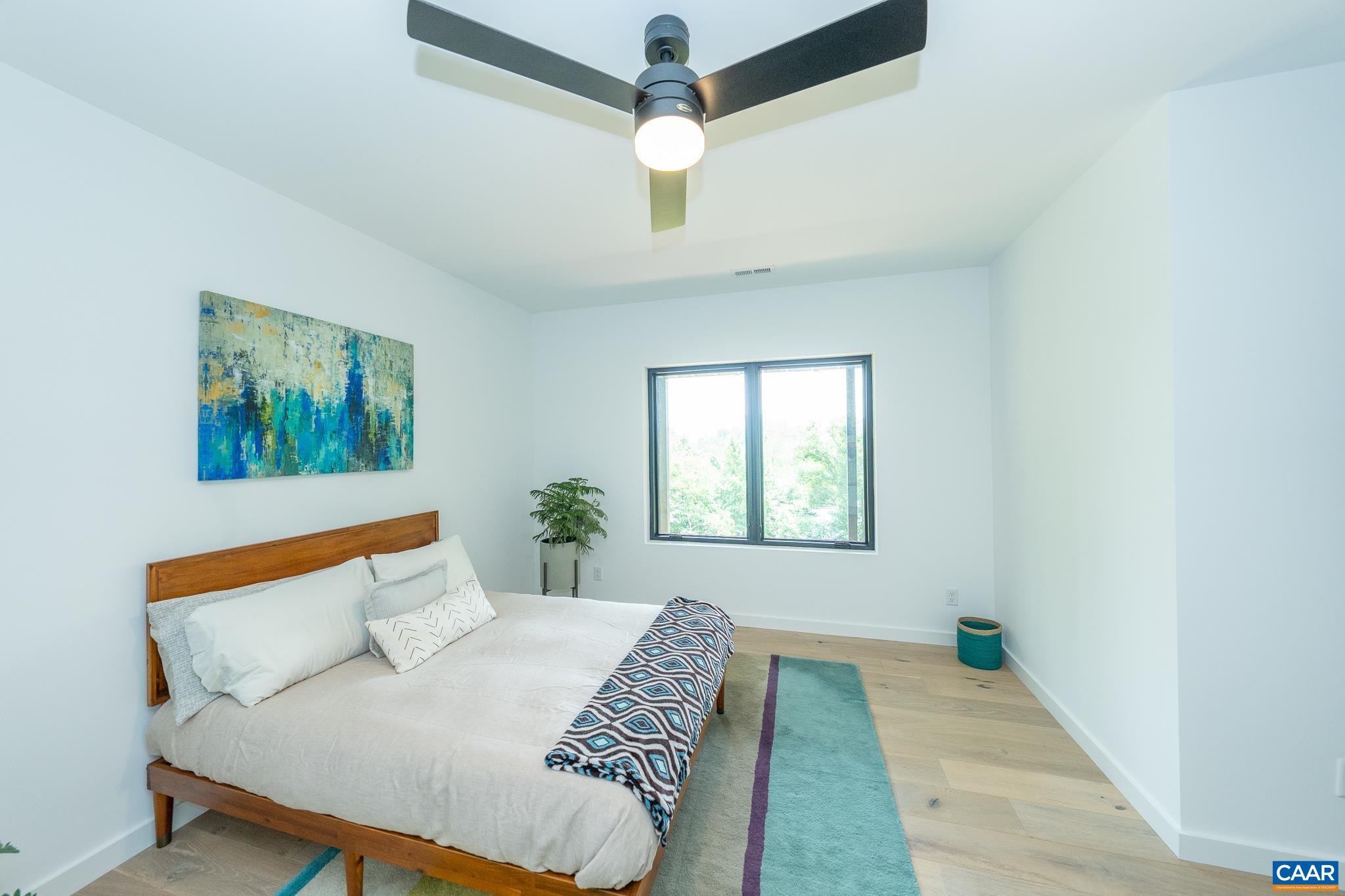 809 Gilliams Mountain Road Charlottesville, VA 22903 - Photo 63 of 68 a bedroom with a large bed and a chandelier