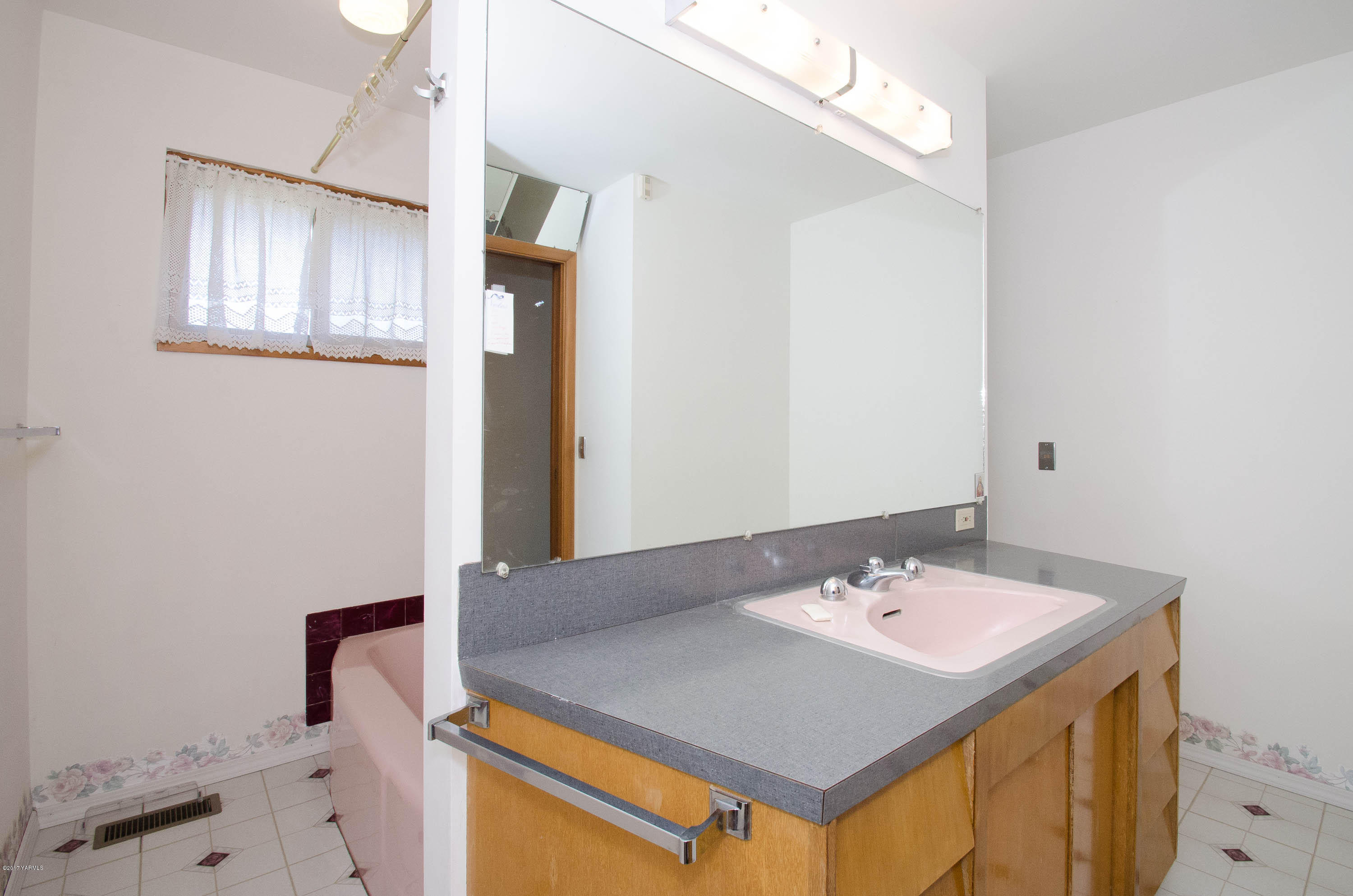 3591 Harrah Road Harrah, WA 98933 - Photo 14 of 20 a bathroom with a sink vanity and a mirror