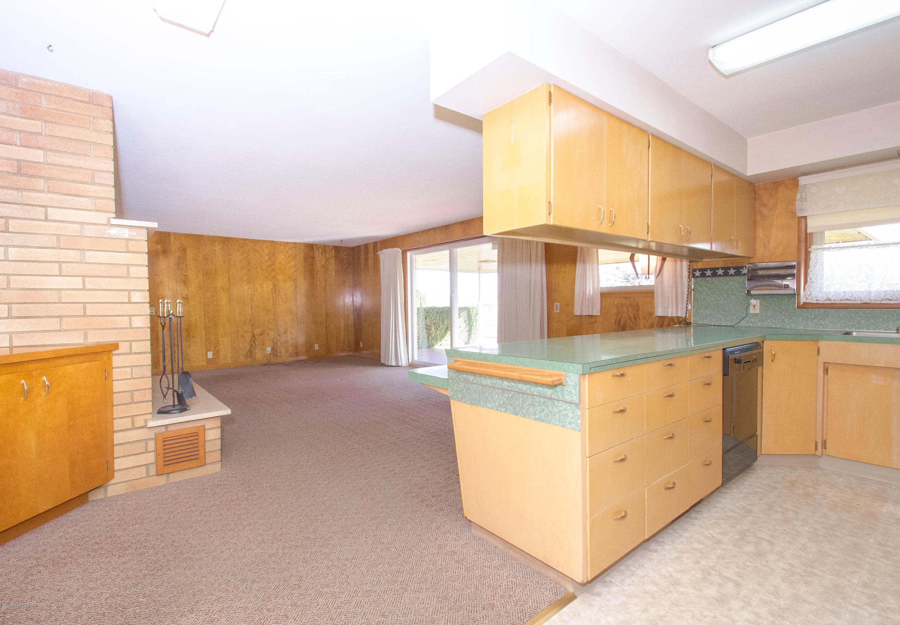 3591 Harrah Road Harrah, WA 98933 - Photo 4 of 20 a kitchen with granite countertop a sink and white cabinets