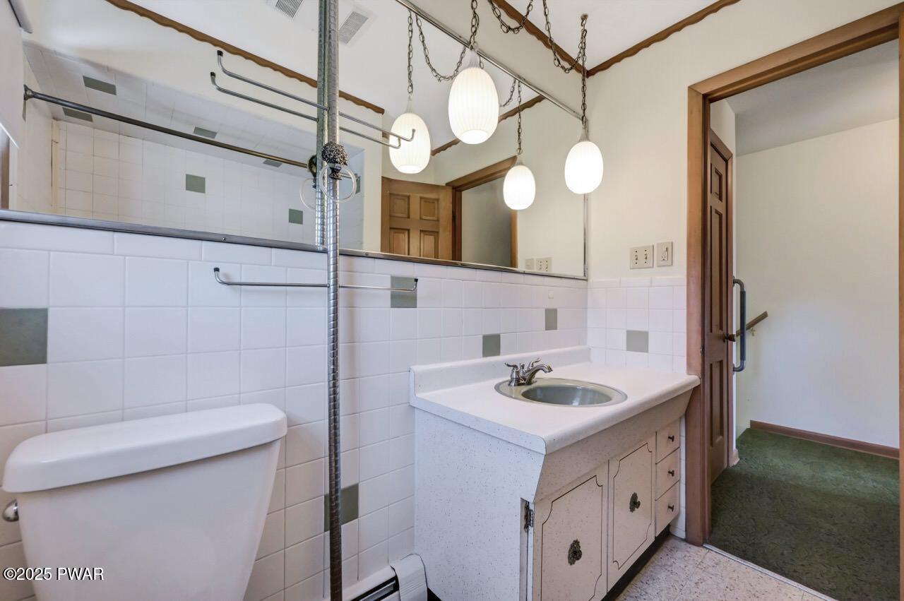 100 Spring Hill Road Moscow, PA 18444 - Photo 39 of 101 a bathroom with a sink a toilet and mirror