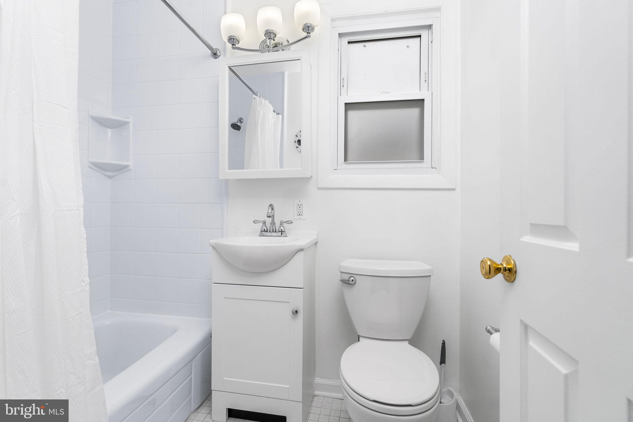 313 Park Hall South Laurel, MD 20724 - Photo 16 of 30 a white toilet sitting next to a bathroom sink