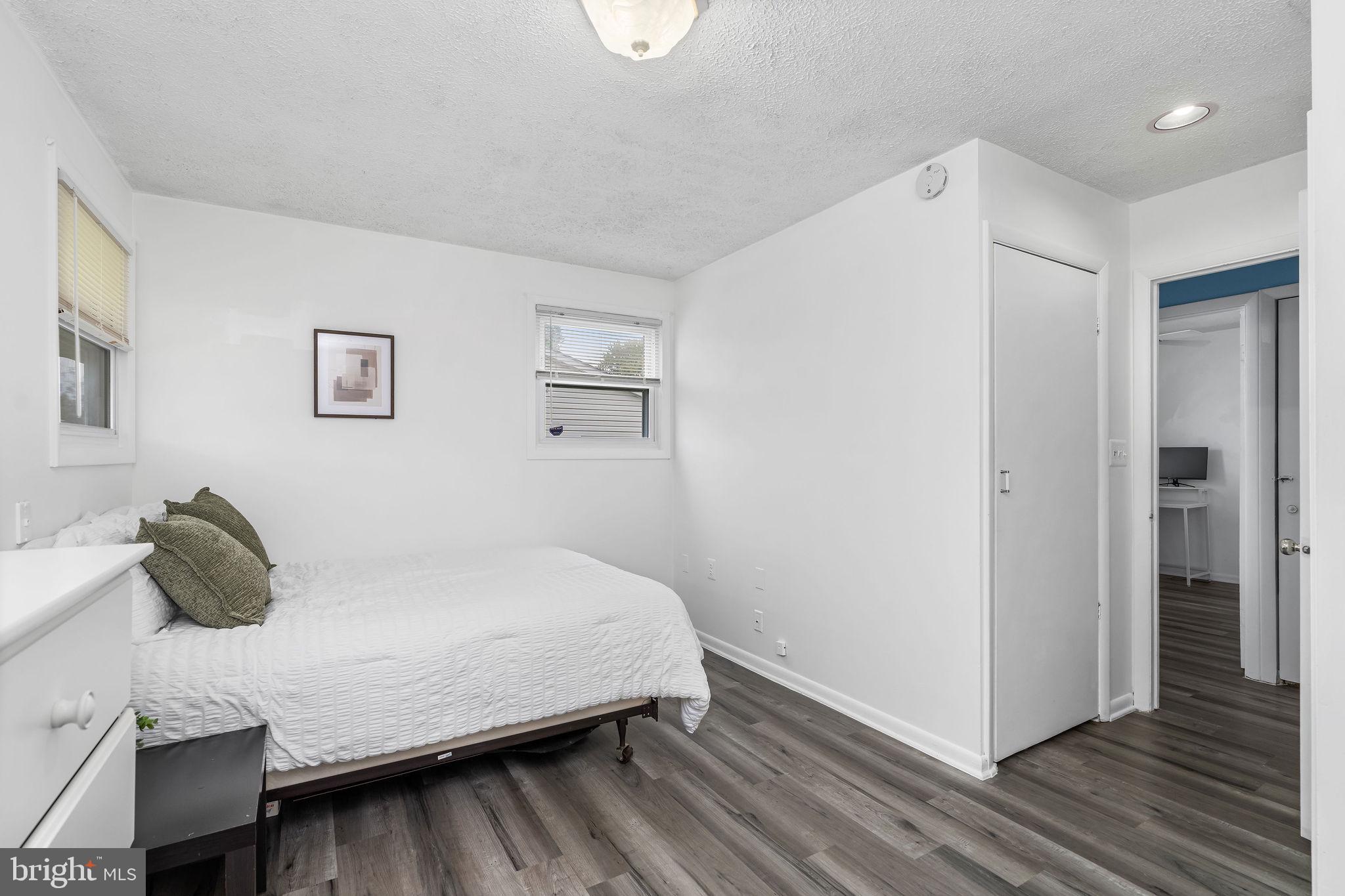 313 Park Hall South Laurel, MD 20724 - Photo 19 of 30 a bedroom with a bed and wooden floor