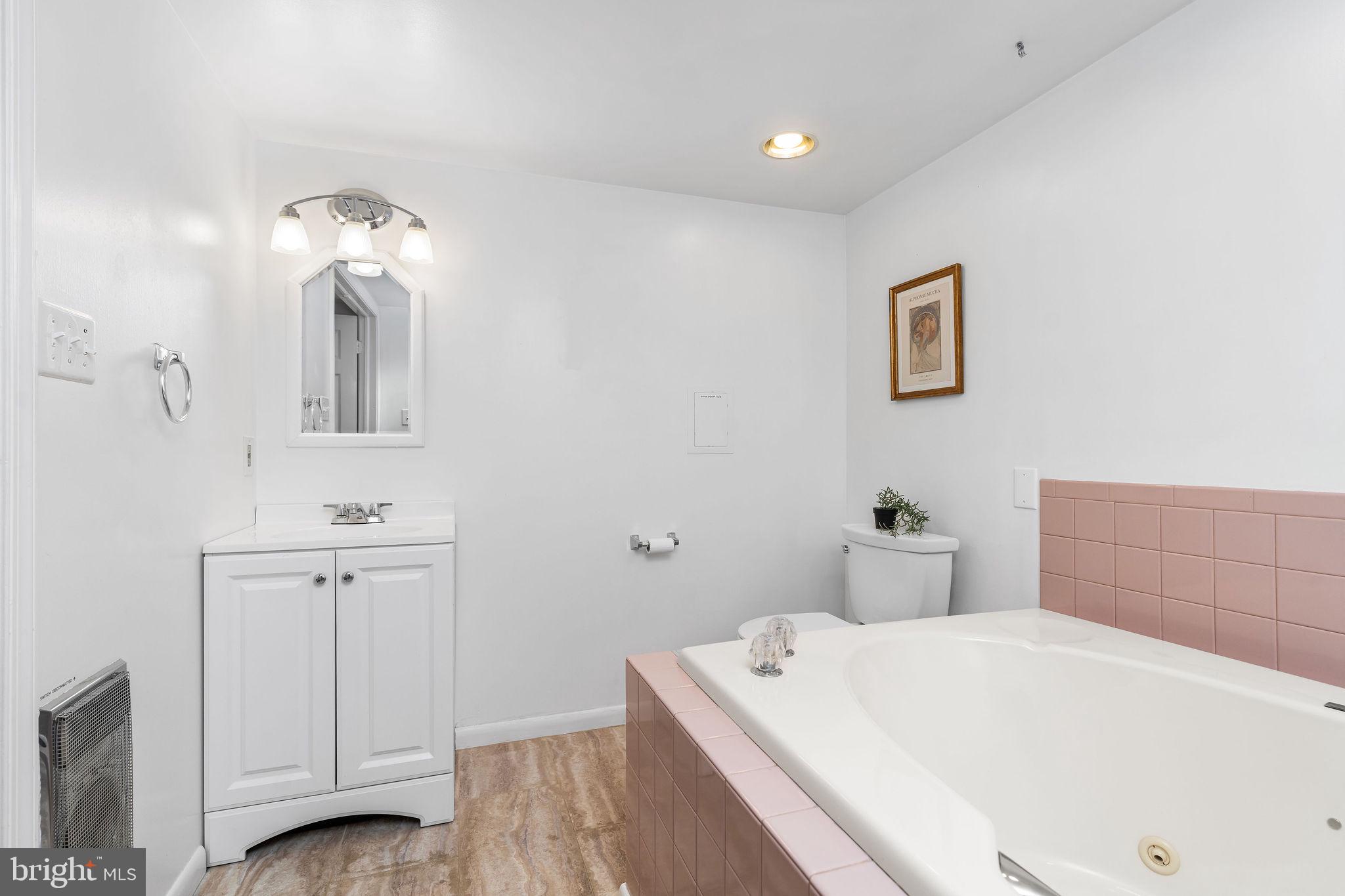 313 Park Hall South Laurel, MD 20724 - Photo 21 of 30 a bathroom with a tub sink and mirror