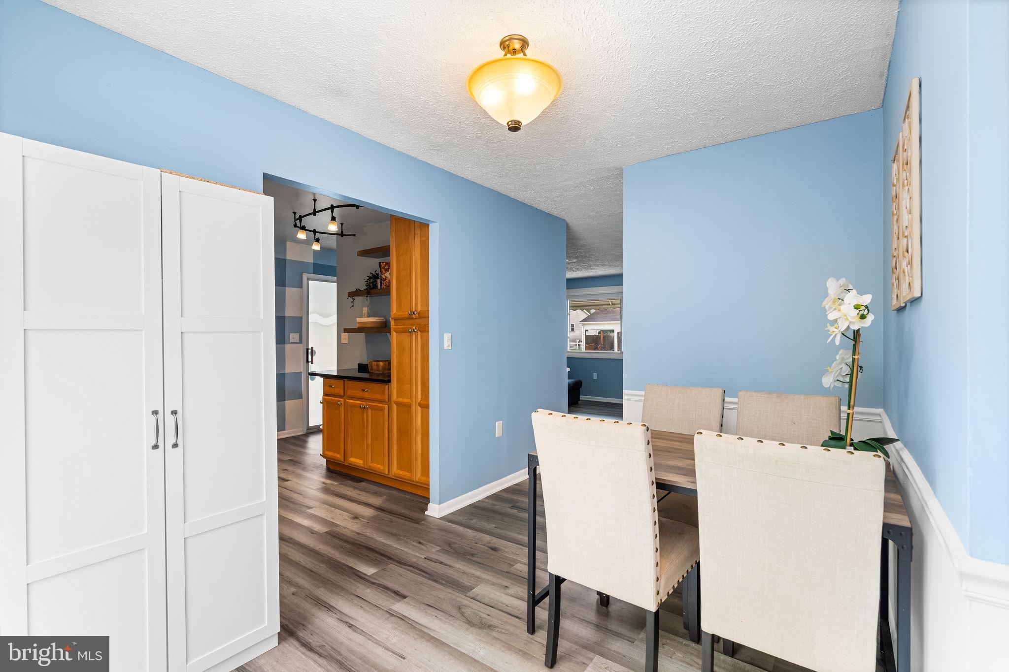 313 Park Hall South Laurel, MD 20724 - Photo 8 of 30 a view of a dining room with furniture and wooden floor