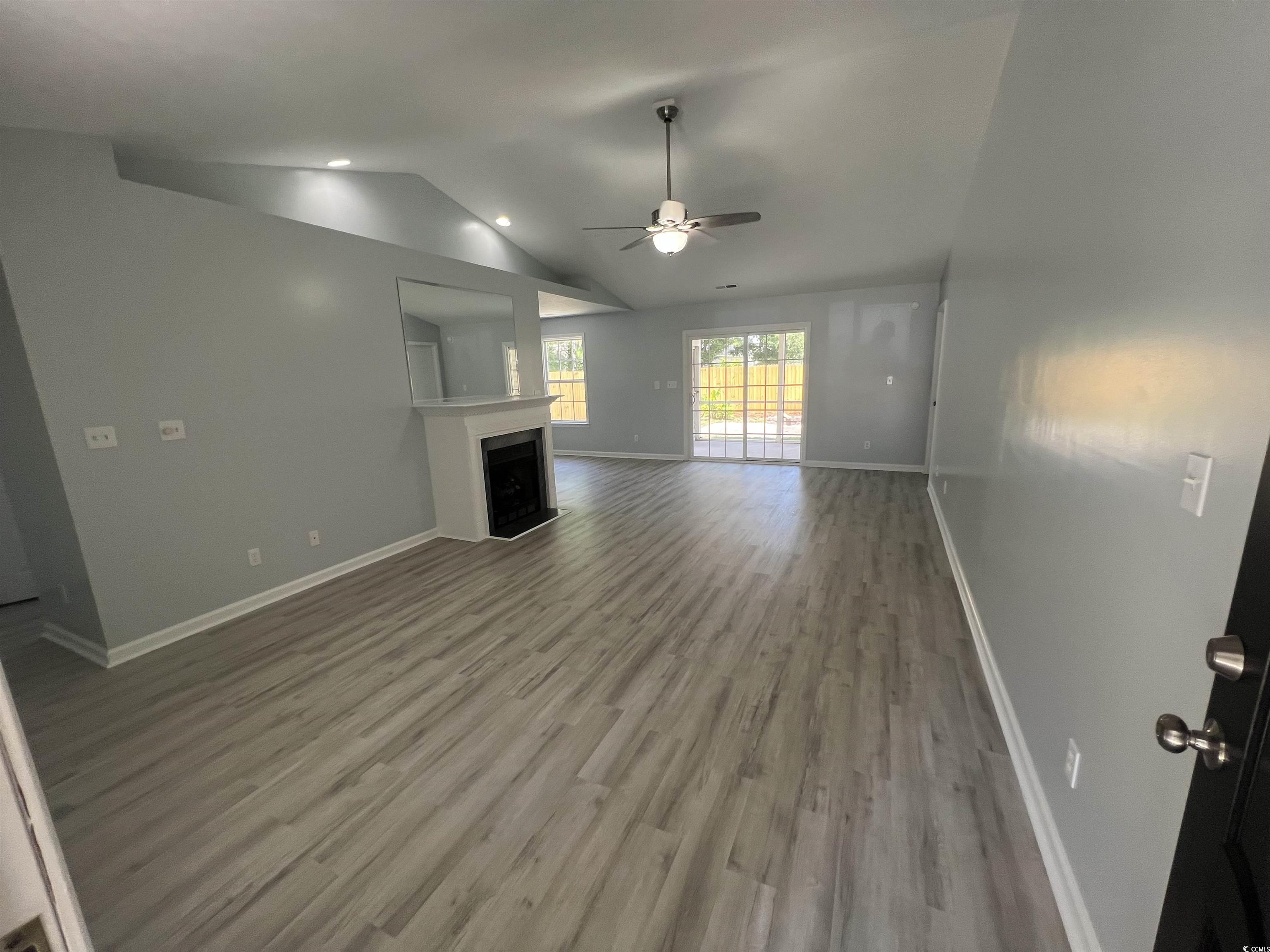 9888 Conifer Lane Murrells Inlet, SC 29576 - Photo 2 of 11 Unfurnished living room featuring a fireplace, cei