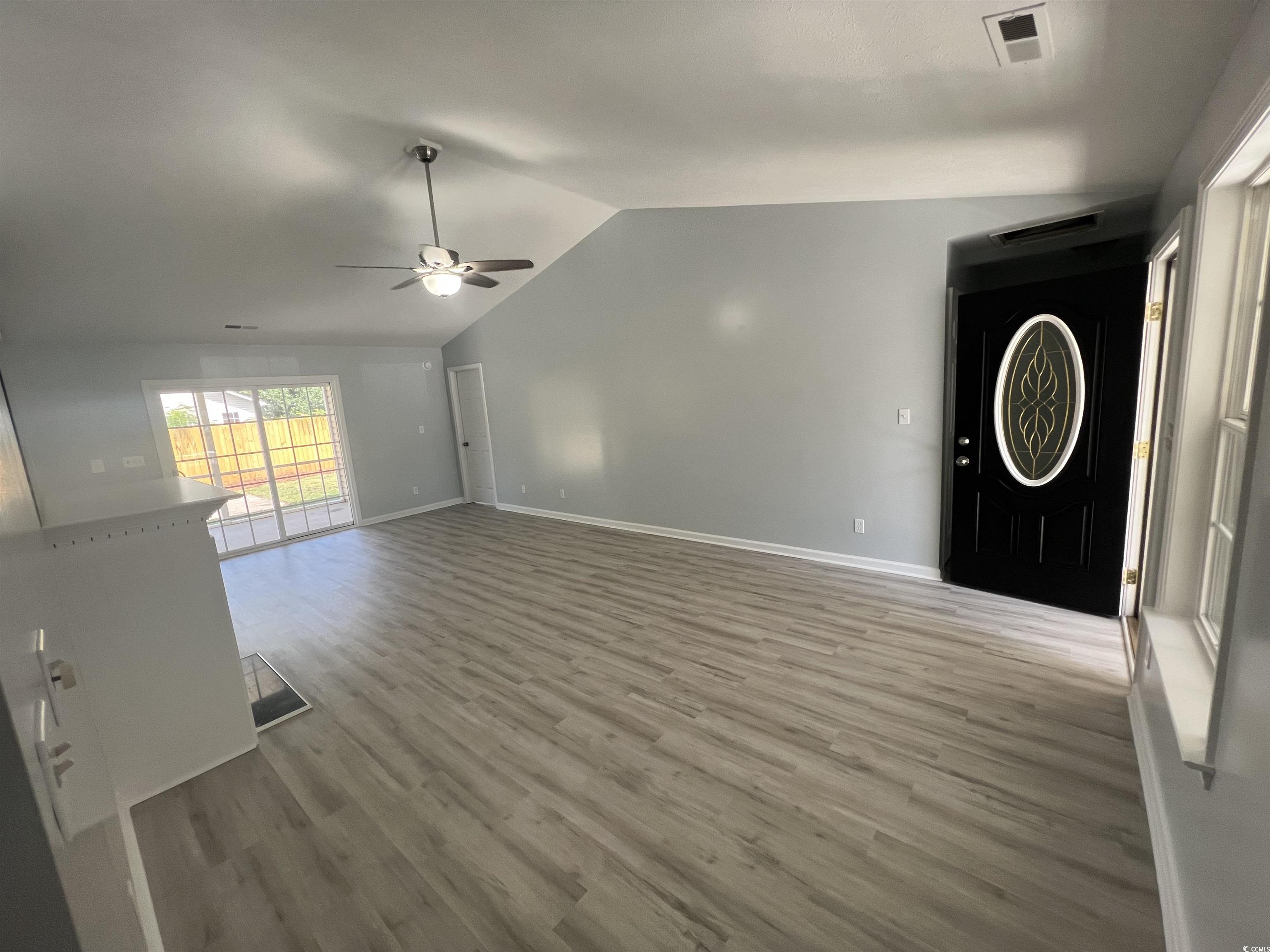 9888 Conifer Lane Murrells Inlet, SC 29576 - Photo 3 of 11 Unfurnished living room featuring a ceiling fan, v