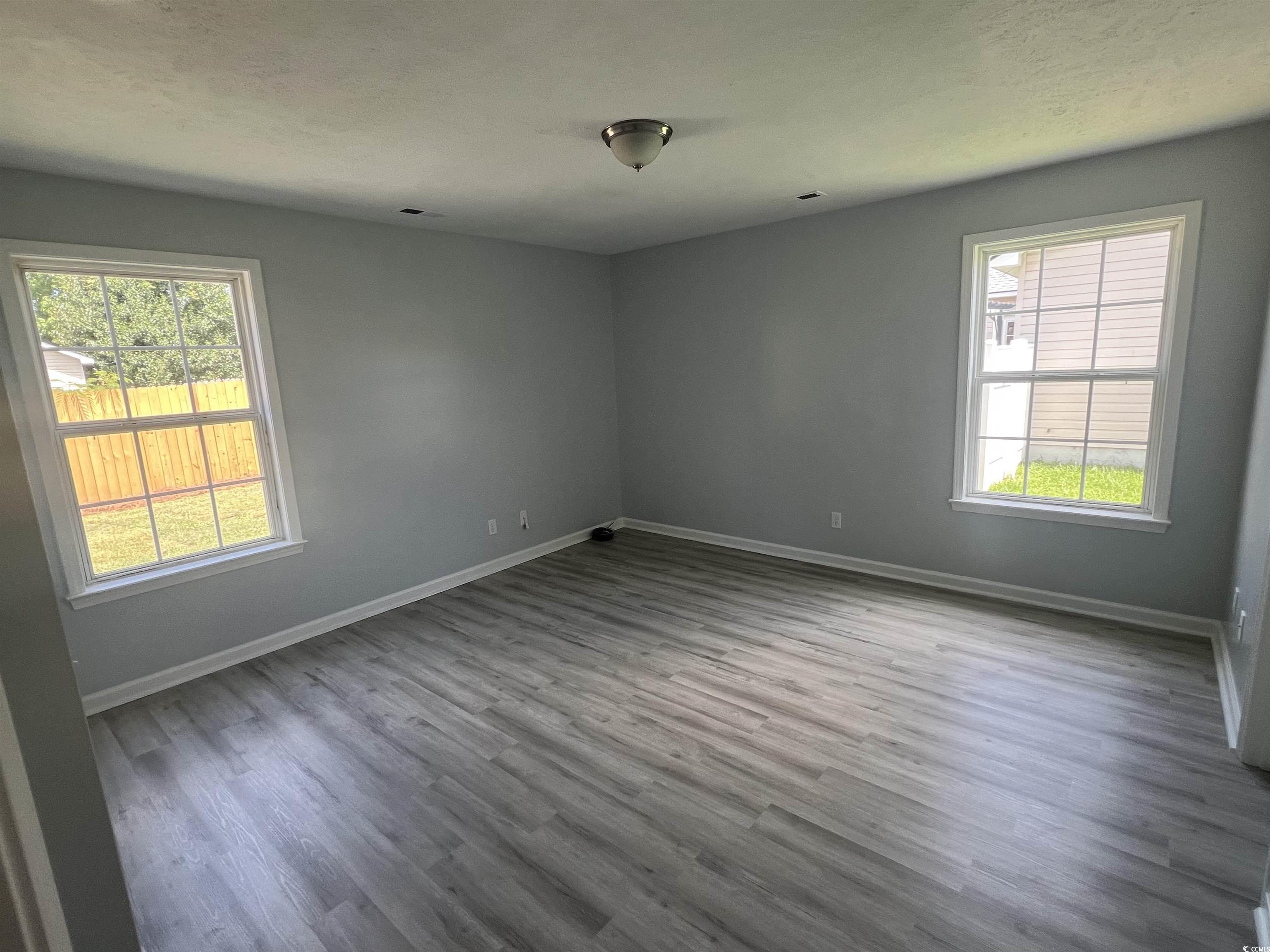 9888 Conifer Lane Murrells Inlet, SC 29576 - Photo 5 of 11 Empty room featuring healthy amount of natural lig