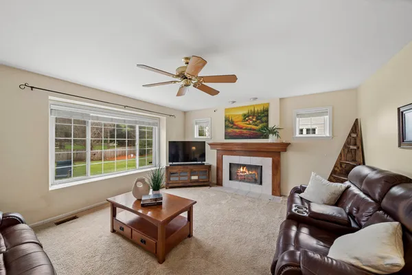 a living room with furniture flat screen tv and a fireplace