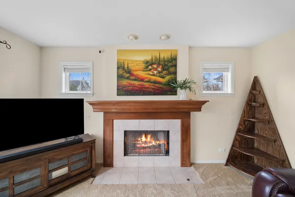 a living room with furniture a flat screen tv and a fireplace