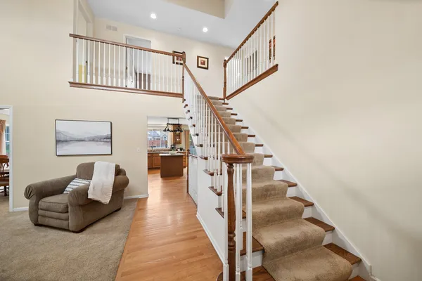 a living room with furniture and stairs