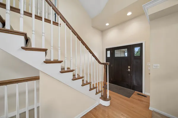 a view of entryway with wooden floor and stairs