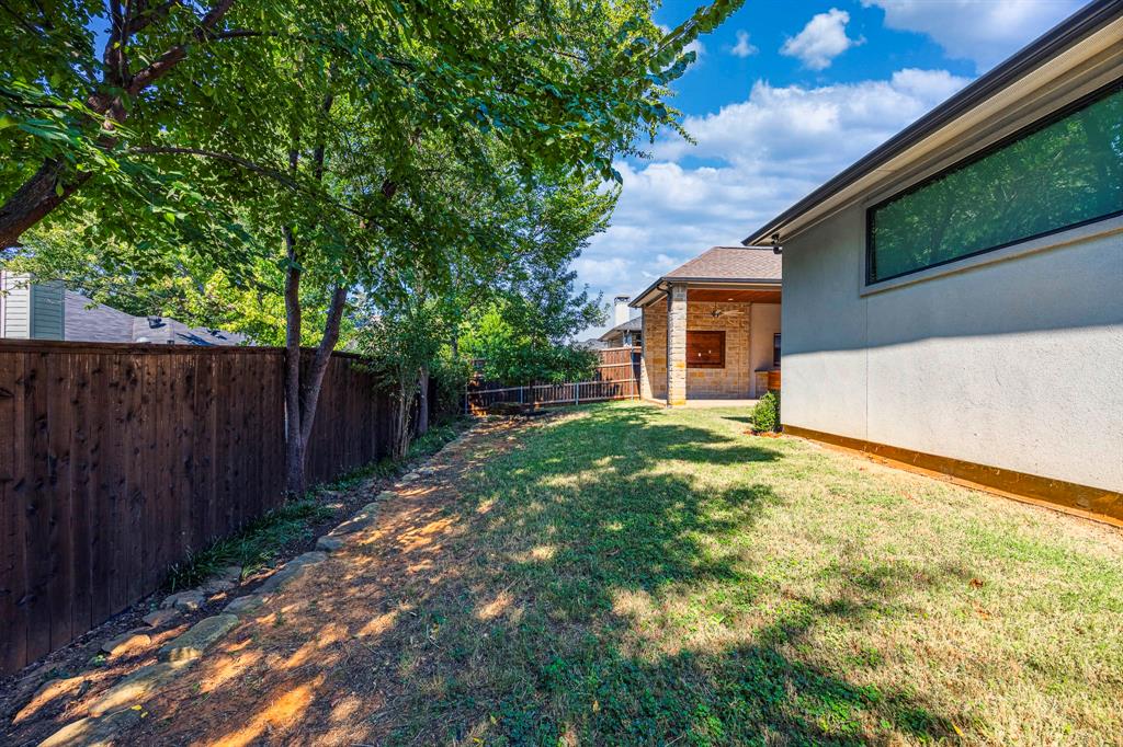 2081 Holt Way Grapevine, TX 76051 - Photo 34 of 40 a backyard of a house with plants and tree